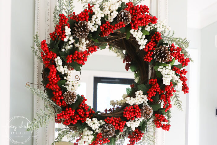 Fun and festive DIY red berry wreath made with items found at the Dollar Store! Budget friendly (and oh so simple) holiday decor! artsychicksrule.com #redberrywreath #diychristmaswreath #dollarstorecrafts #dollarstorewreath