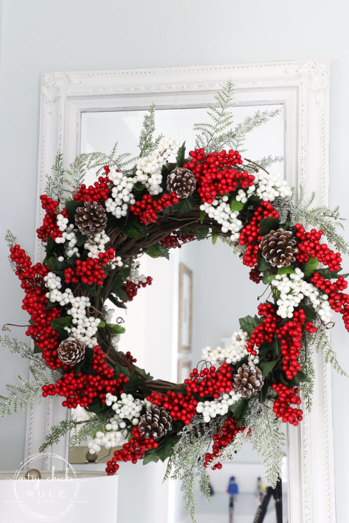 Fun and festive DIY red berry wreath made with items found at the Dollar Store! Budget friendly (and oh so simple) holiday decor! artsychicksrule.com #redberrywreath #diychristmaswreath #dollarstorecrafts #dollarstorewreath