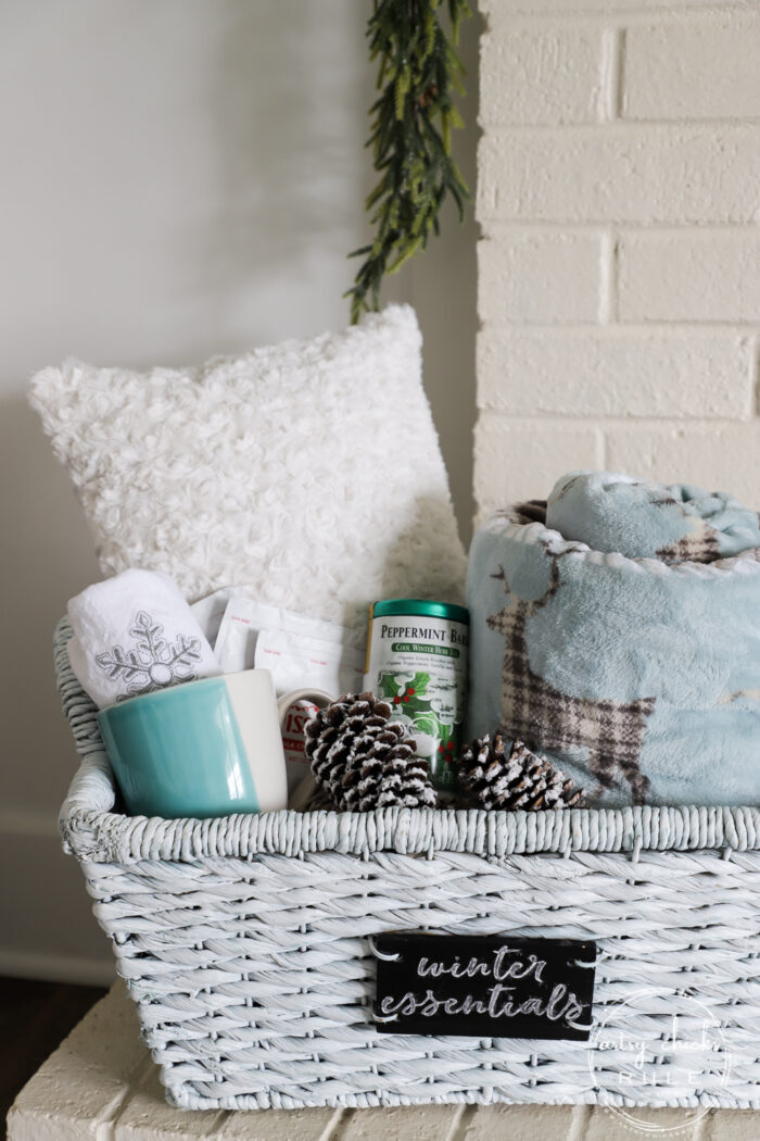 $4 thrift store basket becomes the perfect winter basket for storing winter goodies! Also great for a gift basket with winter essentials! Paint is all you need! artsychicksrule.com #winterbasket #basketmakeover #thriftstorebasket #winterstuff
