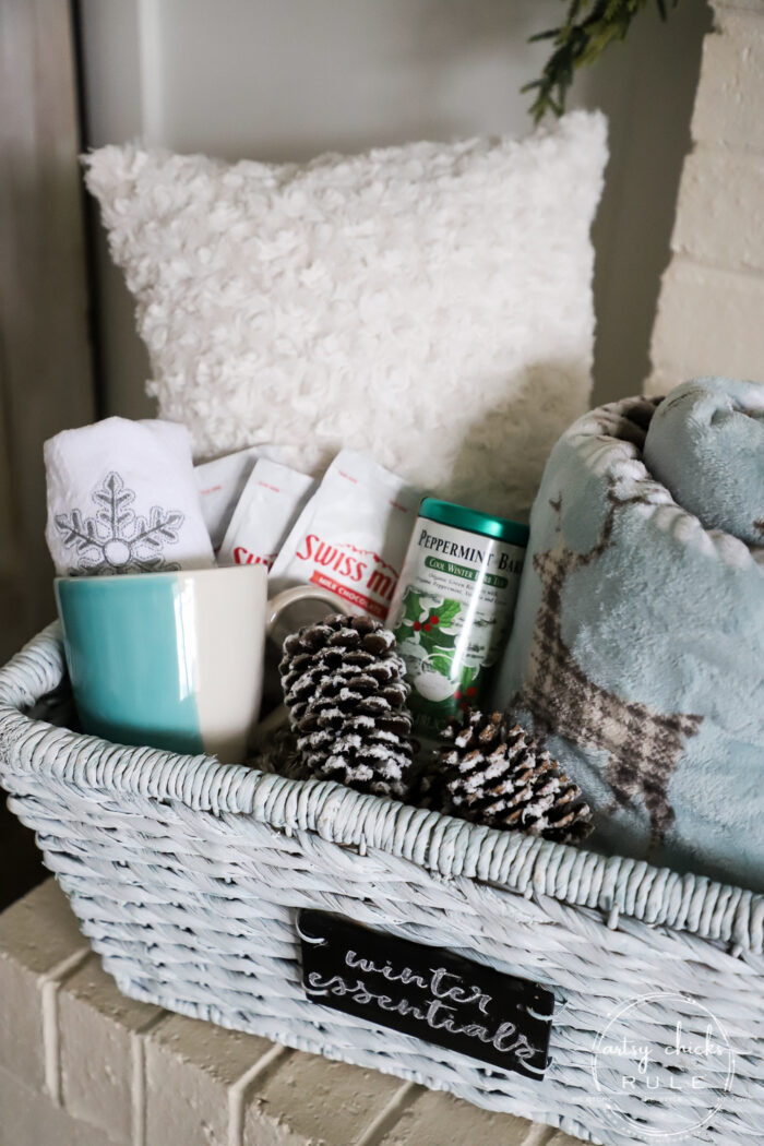 $4 thrift store basket becomes the perfect winter basket for storing winter goodies! Also great for a gift basket with winter essentials! Paint is all you need! artsychicksrule.com #winterbasket #basketmakeover #thriftstorebasket #winterstuff