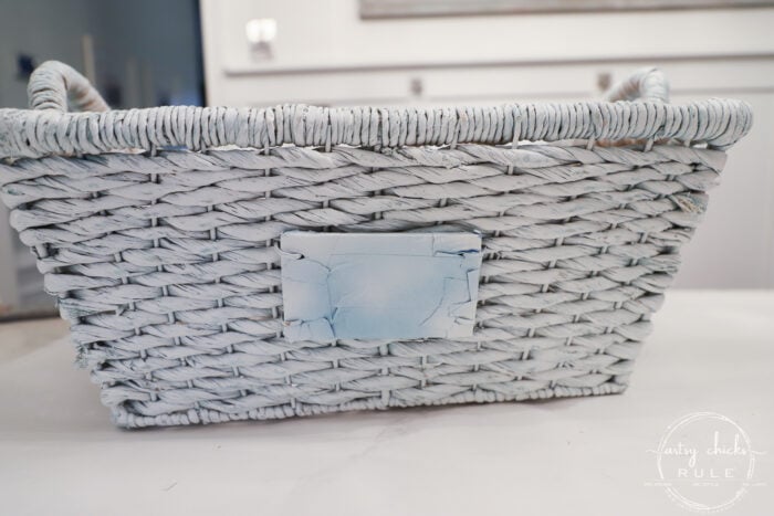 $4 thrift store basket becomes the perfect winter basket for storing winter goodies! Also great for a gift basket with winter essentials! Paint is all you need! artsychicksrule.com #winterbasket #basketmakeover #thriftstorebasket #winterstuff