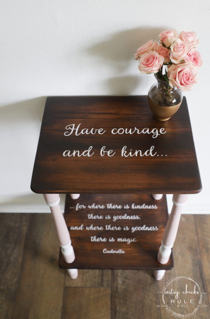 pink and wood stained table with white graphics on both shelves