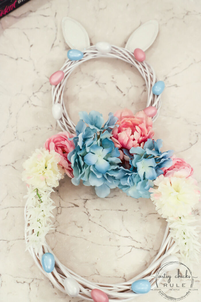 This adorable pink & blue bunny wreath is simple to throw together with just a few items! Perfect for spring and a fun project for kids! artsychicksrule.com #bunnywreath #pinkandbluewreath #springwreath #bunnyprojects