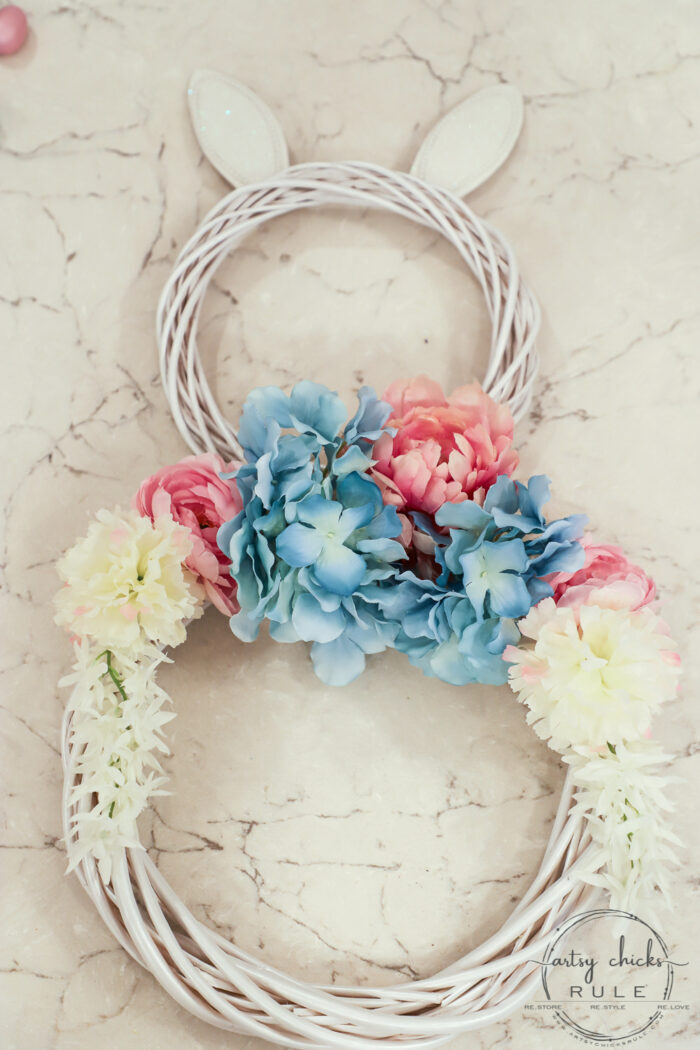 This adorable pink & blue bunny wreath is simple to throw together with just a few items! Perfect for spring and a fun project for kids! artsychicksrule.com #bunnywreath #pinkandbluewreath #springwreath #bunnyprojects