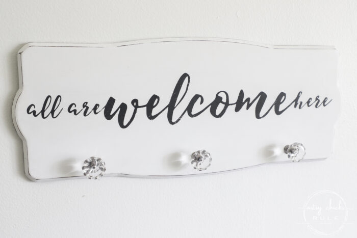 Create a welcoming sign with this "all are welcome here" free graphic I'm sharing! Plus see how I transformed this $3 thrift store find. artsychicksrule.com #freeprintable #allarewelcomehere #welcomesign #silhouettecameo