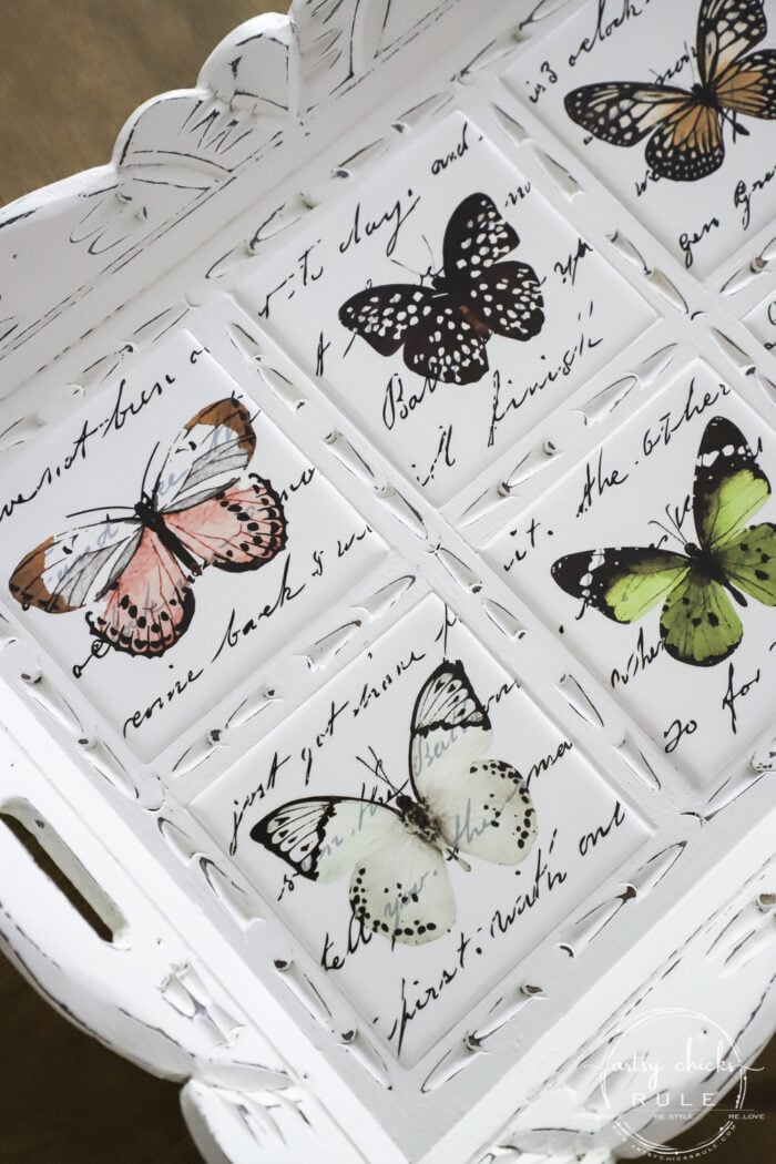 white painted tile with colorful butterflies on each one