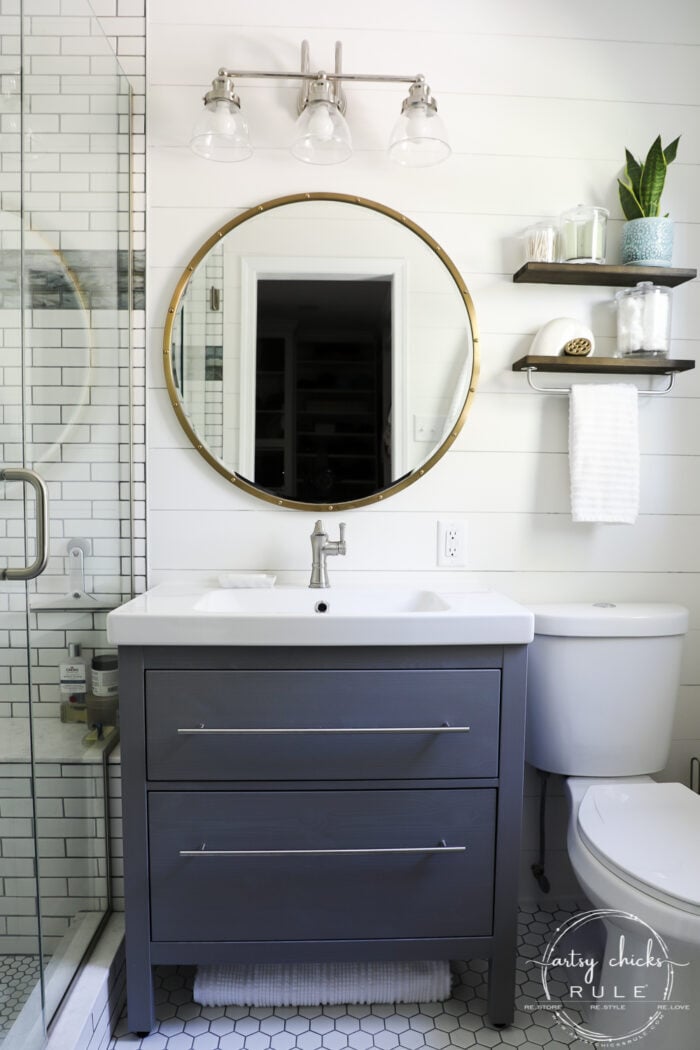 bathroom sink, mirror, toilet with white shiplap