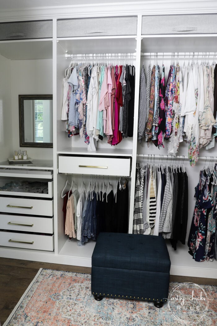 white closet with colorful clothes hanging