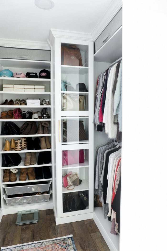 We created a "custom, built-in" master closet look with basic IKEA PAX closet system cabinets simply by adding trim and a few extra touches! artsychicksrule.com #builtincloset #ikeapax #paxclosethack #ikeapaxideas