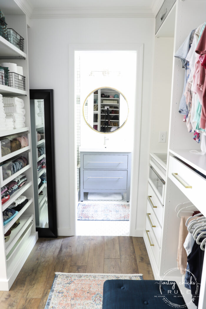 We created a "custom, built-in" master closet look with basic IKEA PAX closet system cabinets simply by adding trim and a few extra touches! artsychicksrule.com #builtincloset #ikeapax #paxclosethack #ikeapaxideas