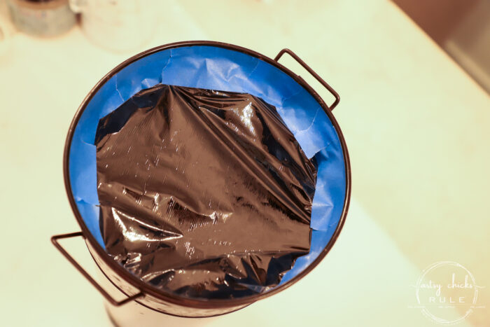 french floral bucket taped with plastic wrap to protect while spray painting