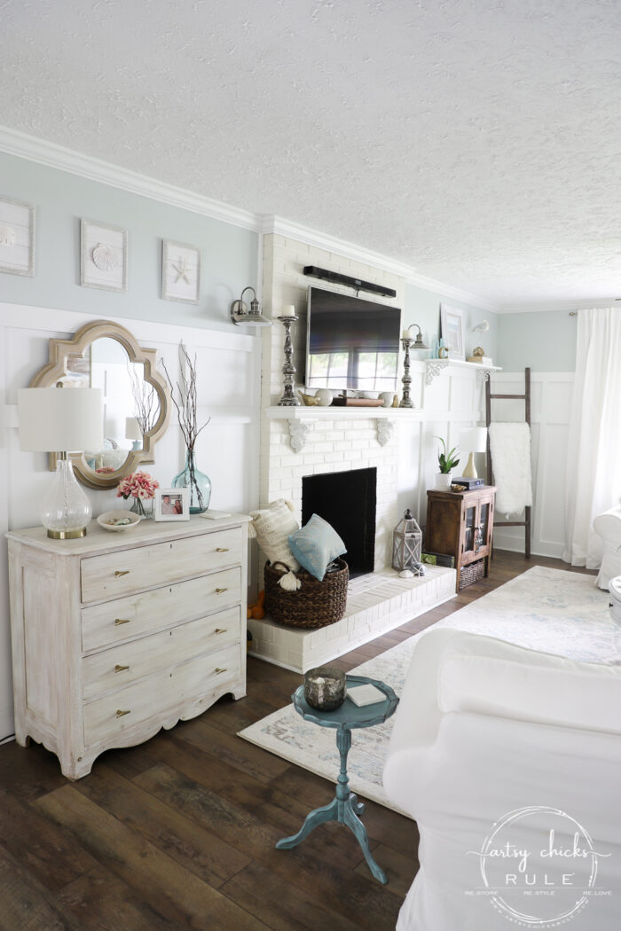 Coastal living room white stained chest brown laminate flooring