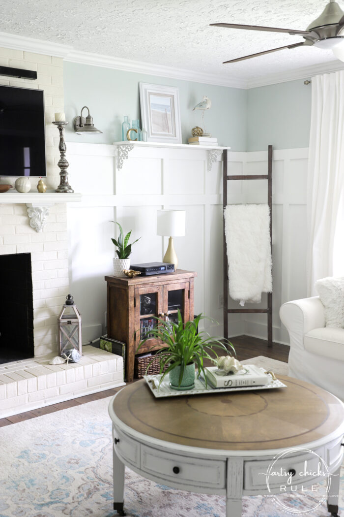 Coastal beachy style living room with round coffee table and thrifty decor