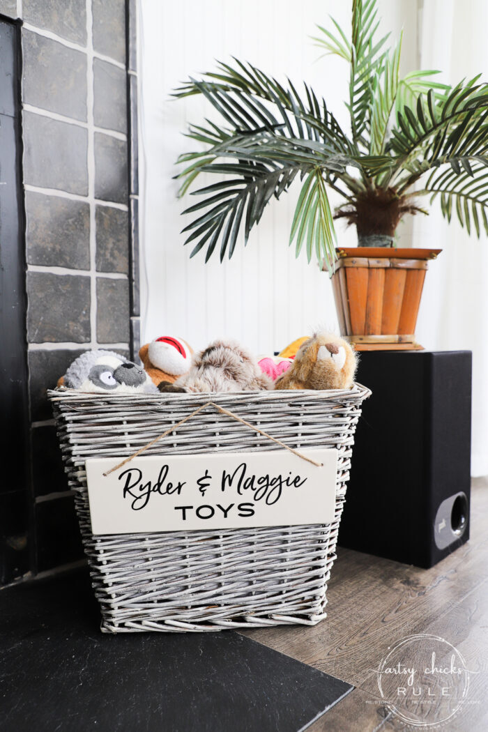 Create a dog toy basket simply out of an old thrift store basket...change it up with a little paint, a sweet sign, and a few toys! artsychicksrule.com #dogbasket #basketmakeover
