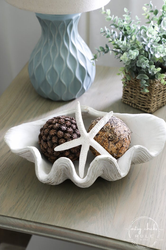 shell bowl on table top with blue lamp