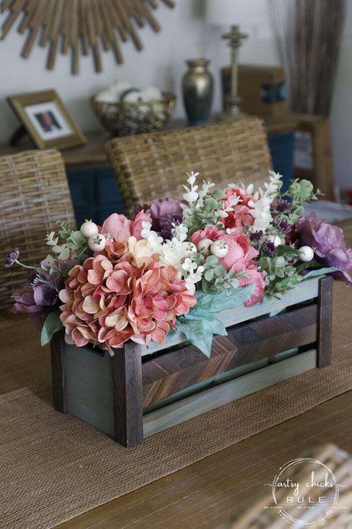 purple, rose, green and ivory florals in green stained wood box