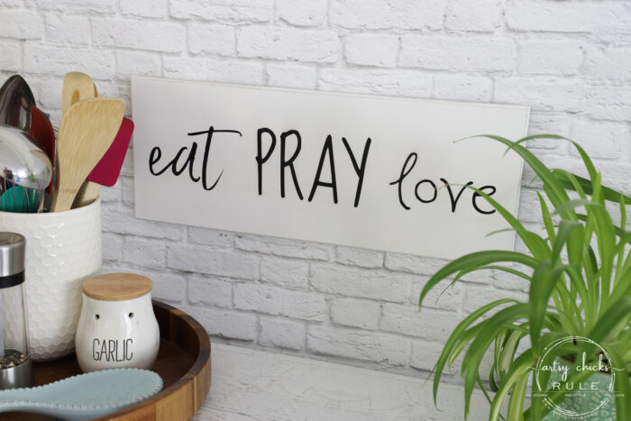 Make these simple kitchen signs out of old thrifted wall decor! Made easy with free graphics and a Silhouette Cameo! artsychicksrule.com #silhouettecameo #kitchensigns #eatpraylove