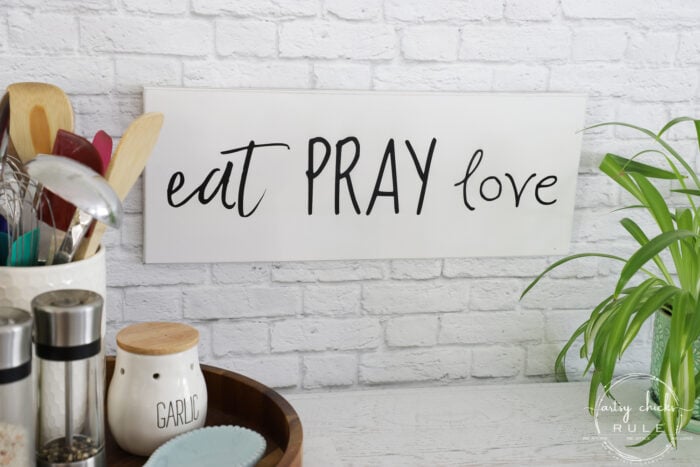 Make these simple kitchen signs out of old thrifted wall decor! Made easy with free graphics and a Silhouette Cameo! artsychicksrule.com #silhouettecameo #kitchensigns #eatpraylove