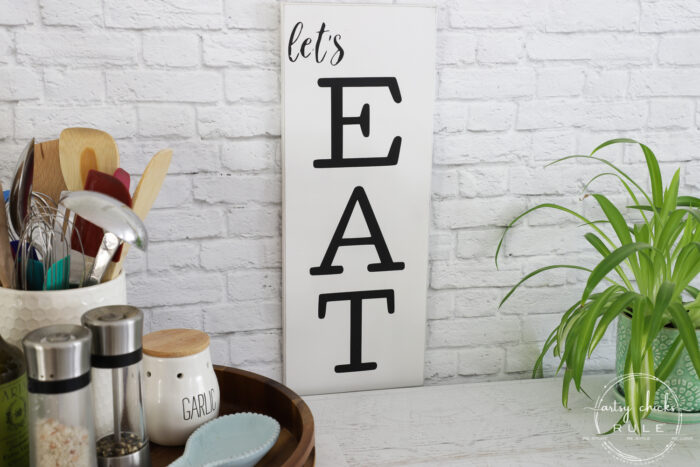 Make these simple kitchen signs out of old thrifted wall decor! Made easy with free graphics and a Silhouette Cameo! artsychicksrule.com #silhouettecameo #kitchensigns #eatpraylove