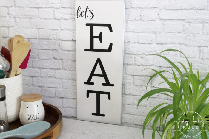 Make these simple kitchen signs out of old thrifted wall decor! Made easy with free graphics and a Silhouette Cameo! artsychicksrule.com #silhouettecameo #kitchensigns #eatpraylove