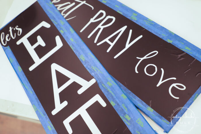 Make these simple kitchen signs out of old thrifted wall decor! Made easy with free graphics and a Silhouette Cameo! artsychicksrule.com #silhouettecameo #kitchensigns #eatpraylove