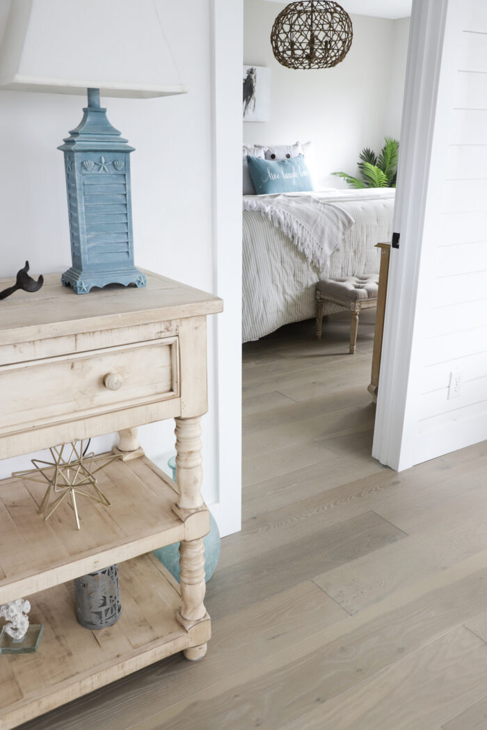 white walls blue lamp wood floor beach house