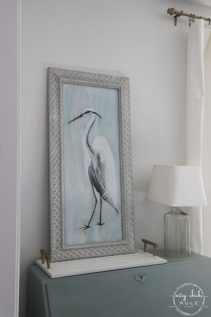 sideways view of blue heron on blue desk