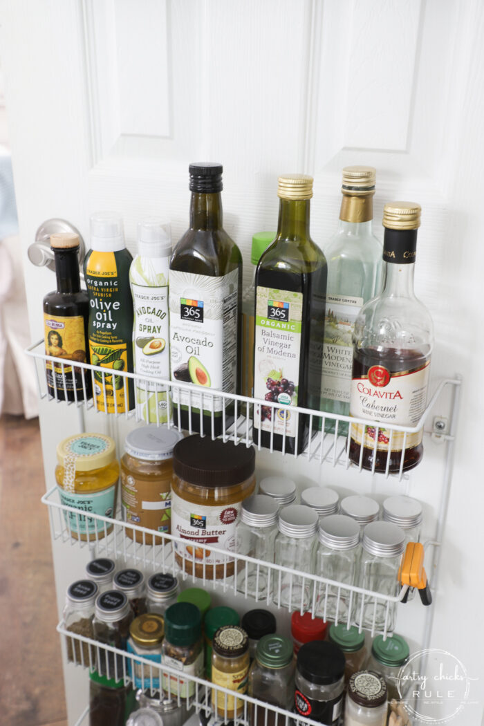 pantry door shelf with vinegar bottles and oils