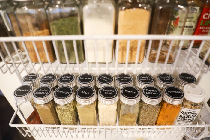 shelves on pantry door with spice bottles