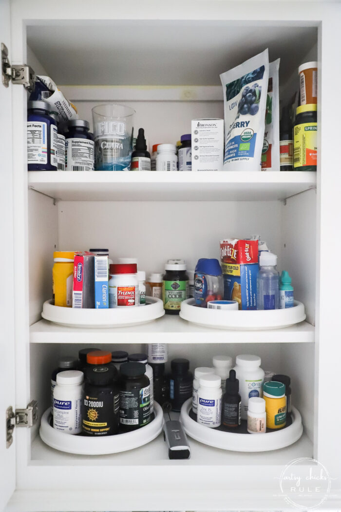medicine and vitamin cabinet with bottles on lazy susan
