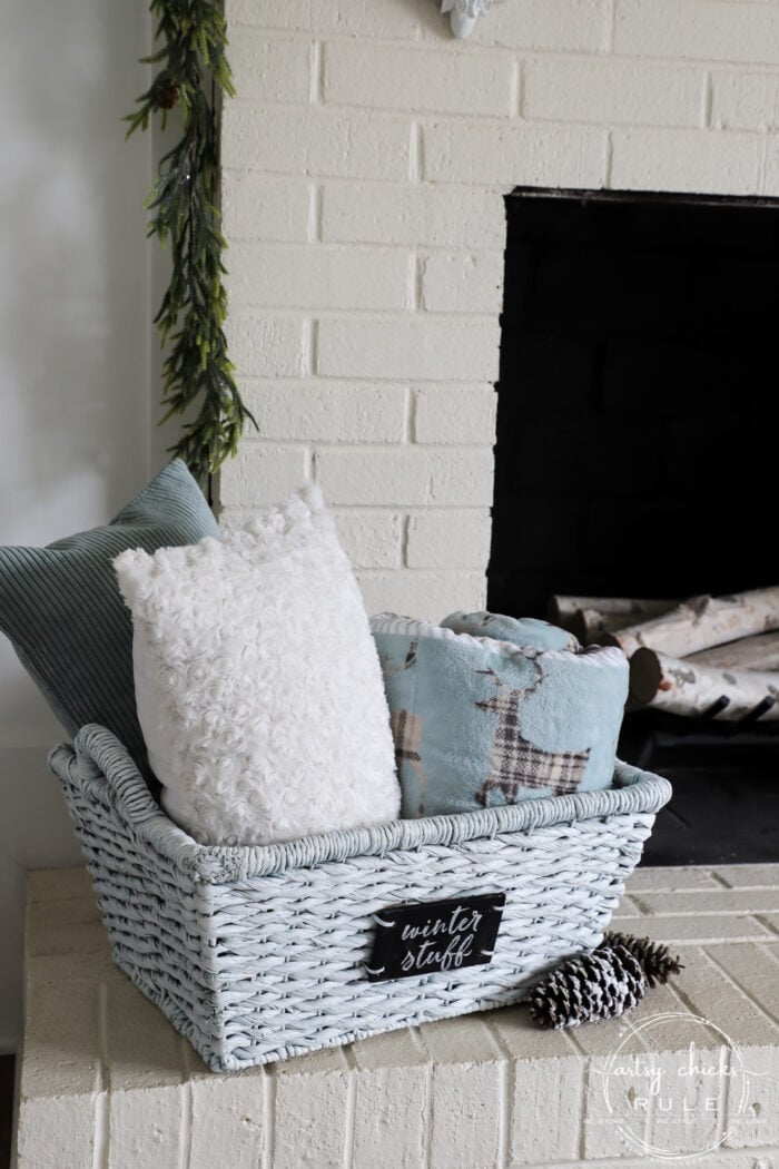 Winter white basket filled with blankets and pillows