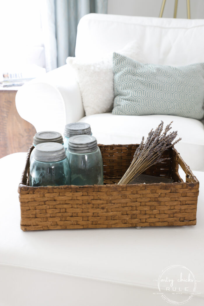 Rectangular basket filled with blue mason jars and lavender