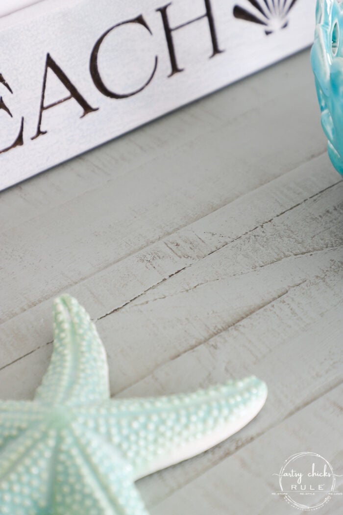 starfish on top of the aqua console with driftwood stained areas prominent