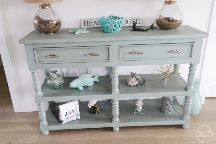 aqua console table decorated with coastal finds