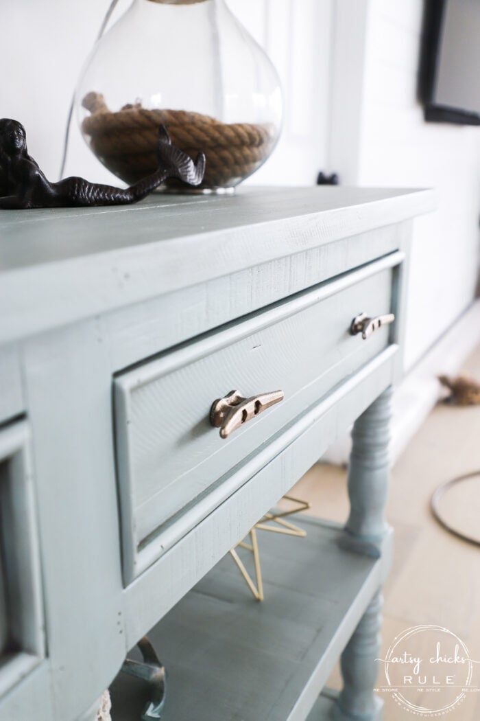 close up side view of aqua console and gold hardware