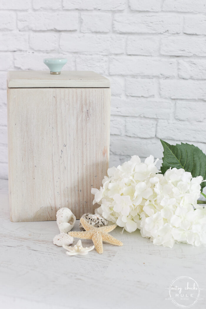 whitewashed wood box with aqua handle and white hydrangeas