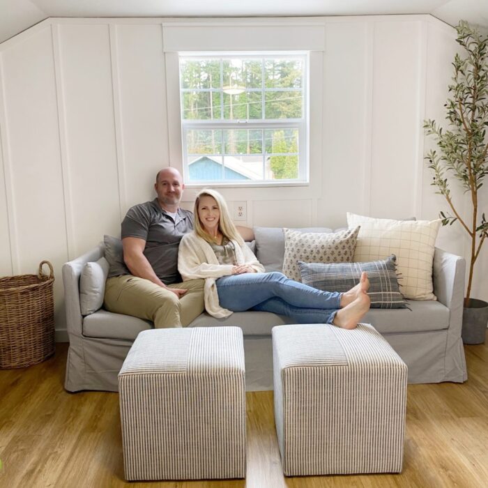 white wall with long strips decorative wood with couch and window