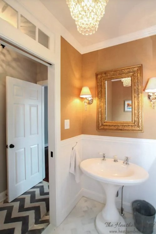 Powder room design with grasscloth wallpaper, vintage pedestal sink and herringbone marble subway tile floor from www.heatherednest.com