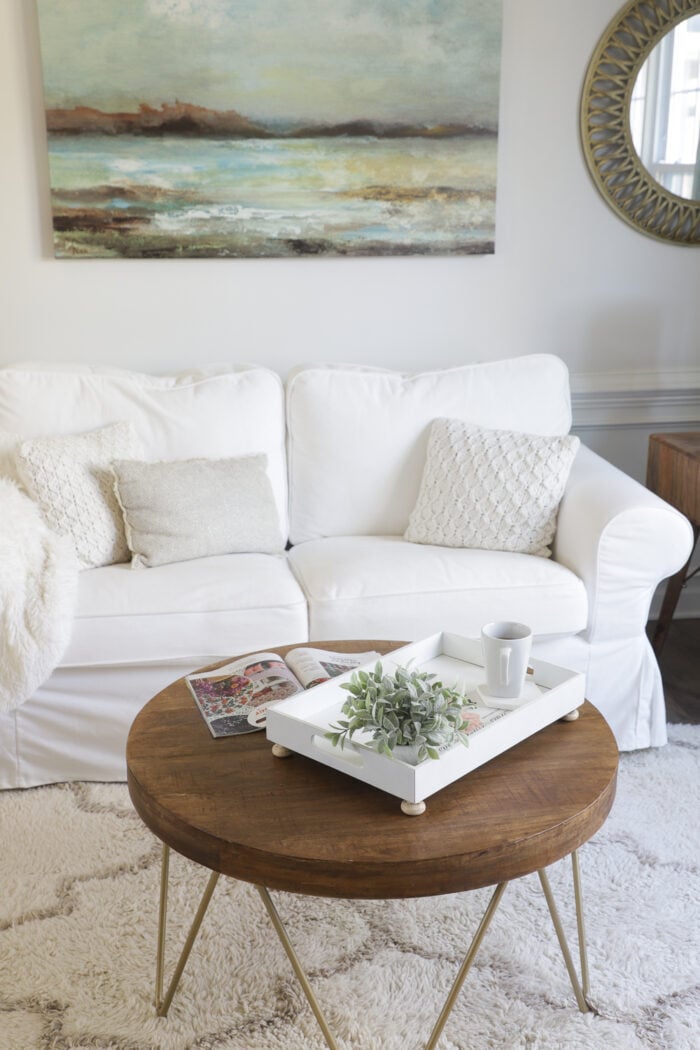 white couch, white tray, wood coffee table