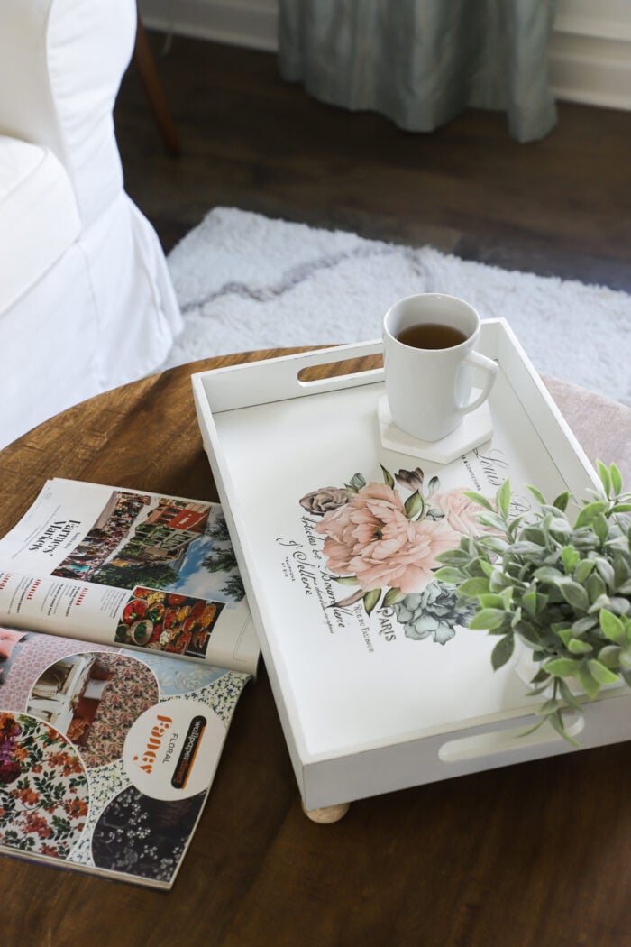 white tray with pink rose on table