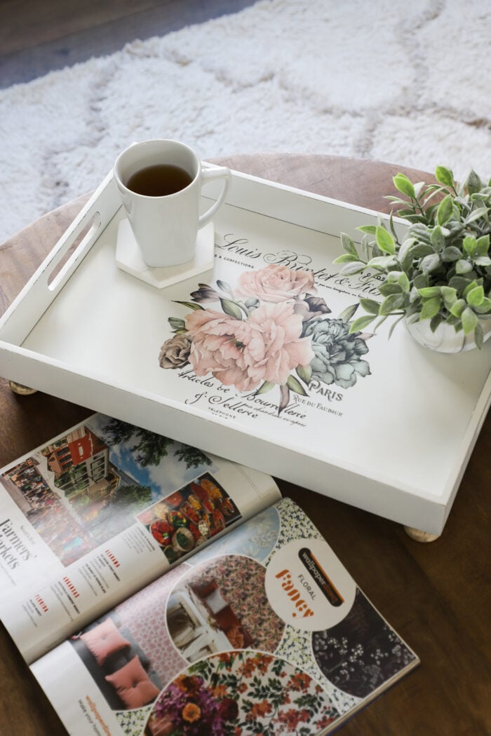 white tray with pink flowers and coffee cup on table
