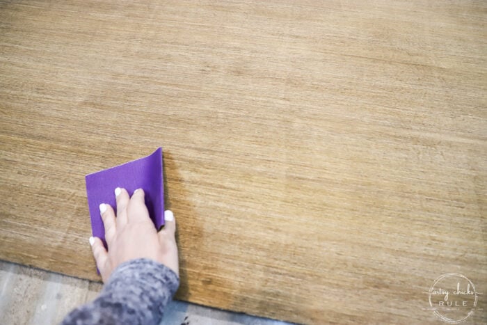 hand sanding stained wood panel