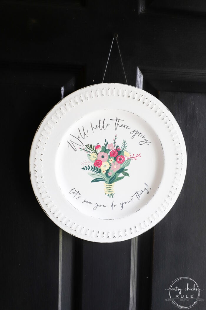 spring sign on platter on black door