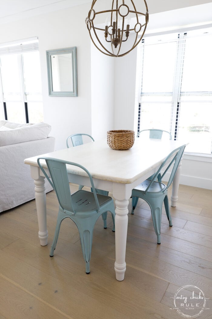 bleached wood top with white legs and blue metal chairs