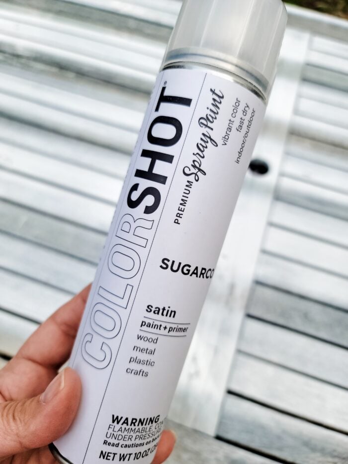 holding can of white colorshot sugarcoat spray paint