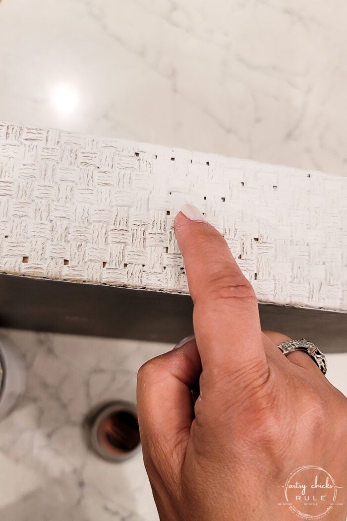 showing how to rub bronze paste on basket