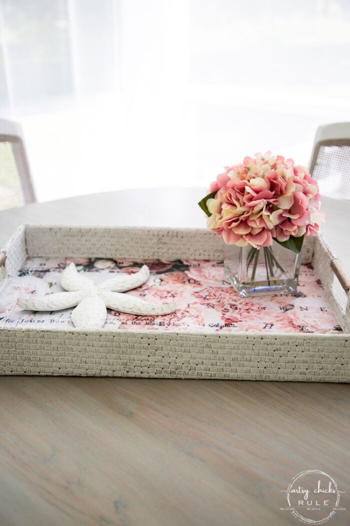 white basket pink tissue paper and pink flower arrangement