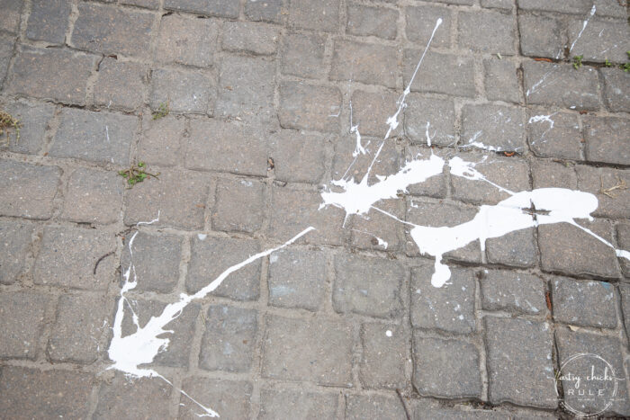 white paint splatter, spill on patio