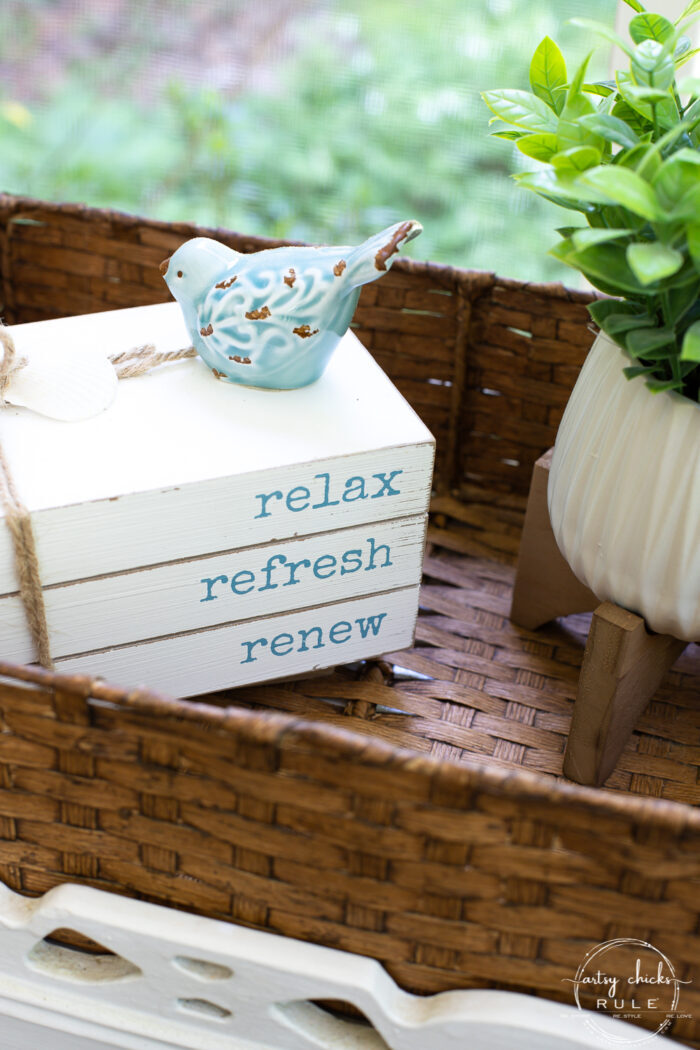 basket with small shrub and blue bird