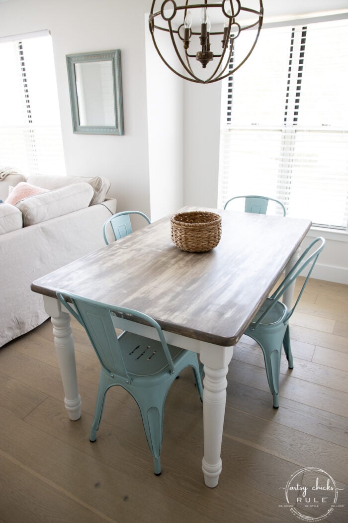 dining area with table and blue chairs